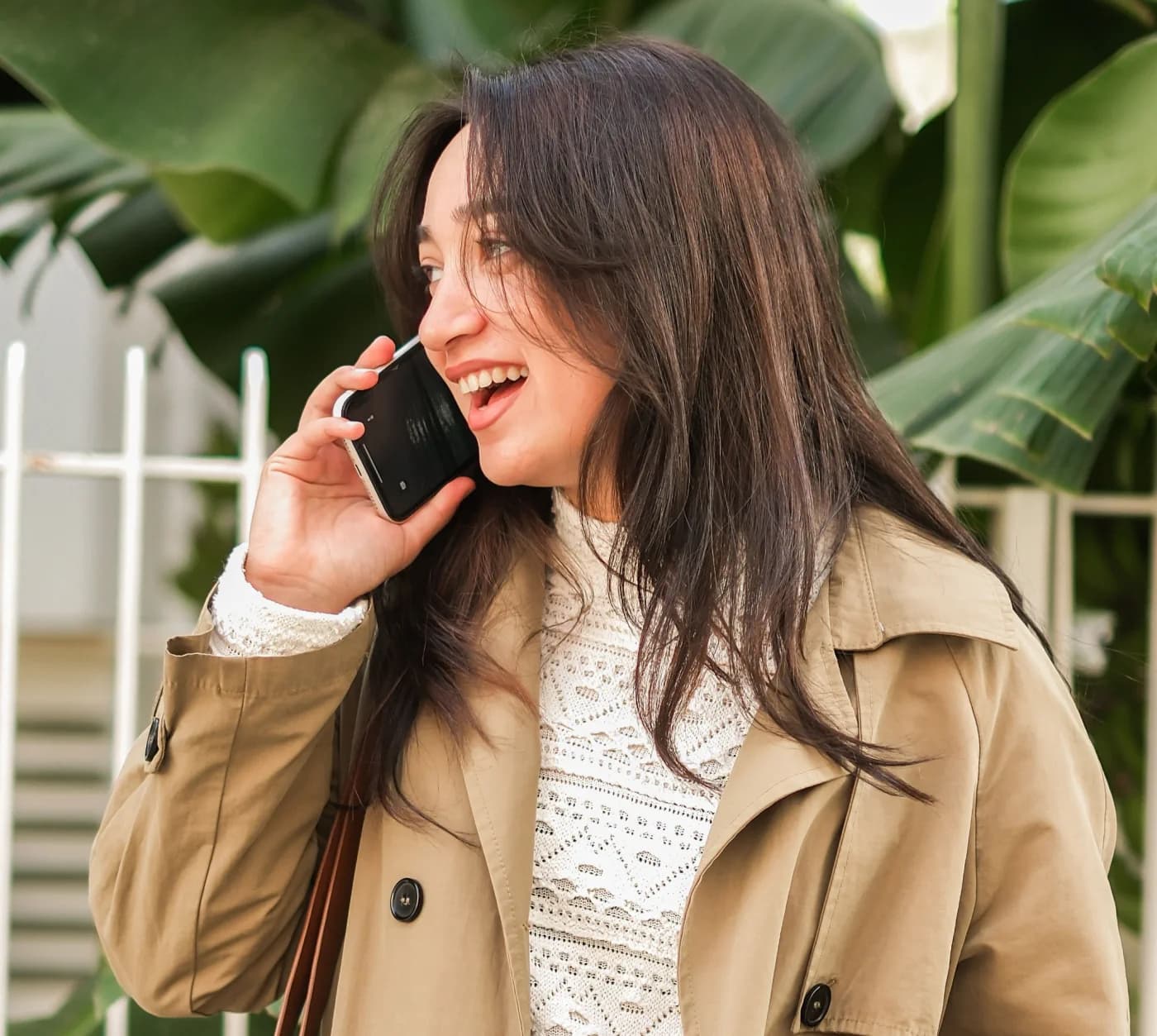Patient smiling while speaking to a dental practice by phone